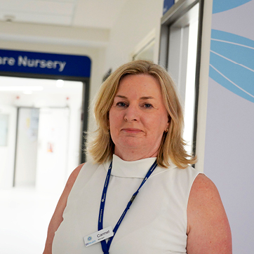 Headshot of Carmel Brophy,  Senior Midwife at GVH Shepparton. She has blonde hair to her shoulders. She is wearing a white sleeveless topy and a blue lanyard.