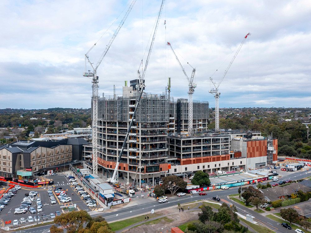 An aerial view of the exterior of Frankston Hospital, with cranes and scaffolding visible