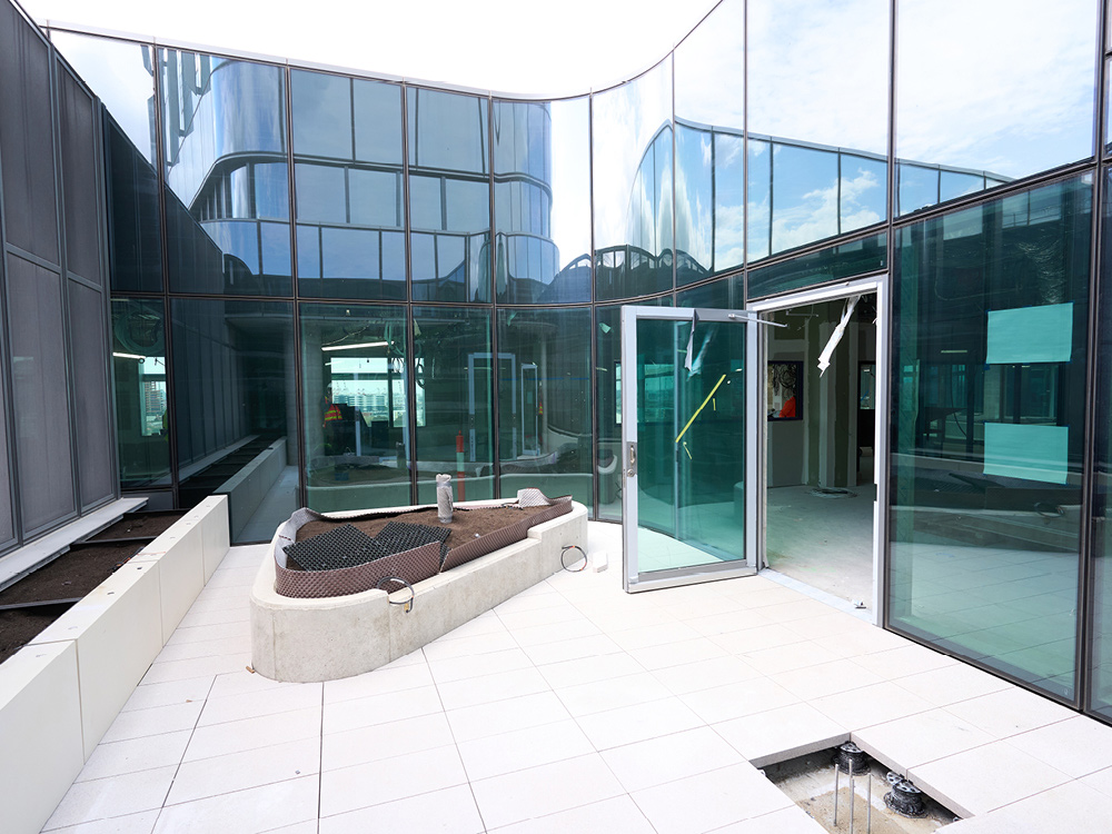 A tiled courtyard with a planter installed