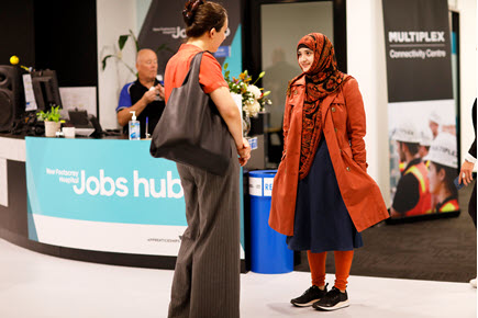 Photograph of two women speaking in front of the counter at the New Footscray Hospital Jobs Hub