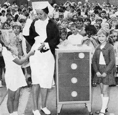 Black and white photo of a nurse and children