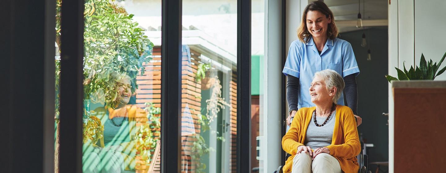 Elderly woman in a wheelchair and her carer at Maffra aged care facility