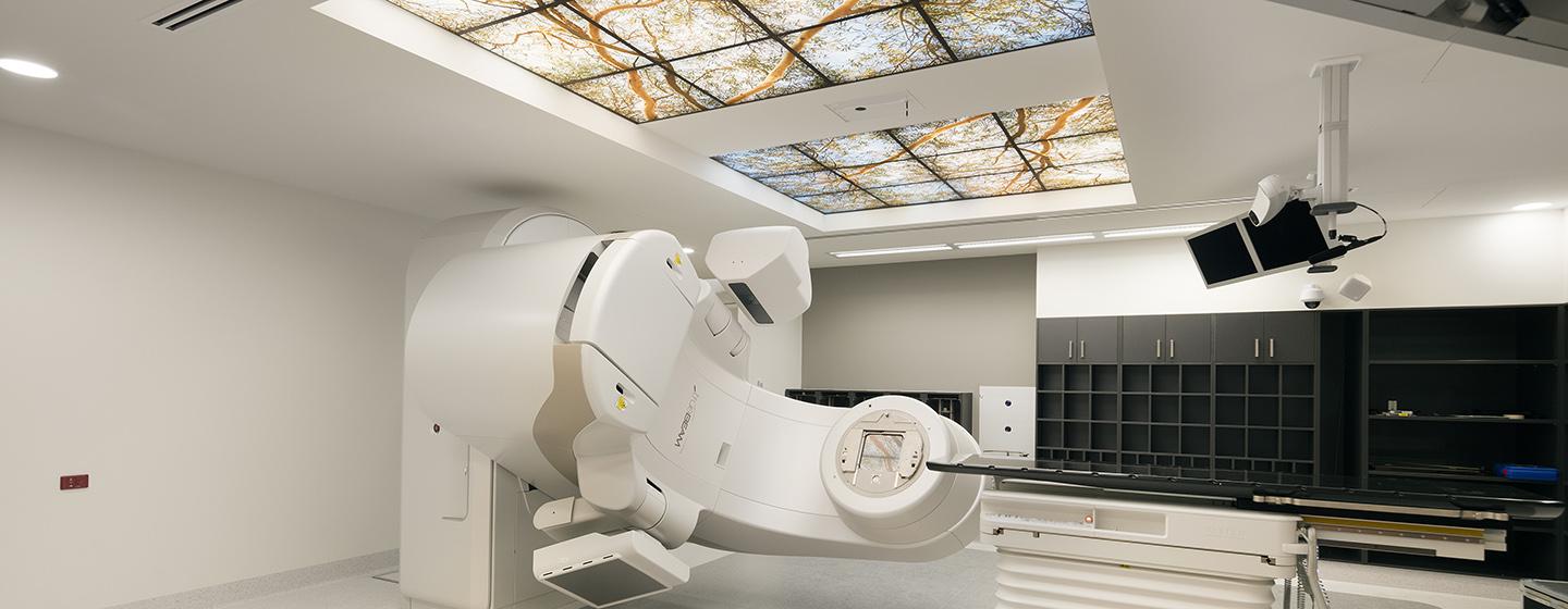 A radiotherapy room with medical equipment and ceiling windows