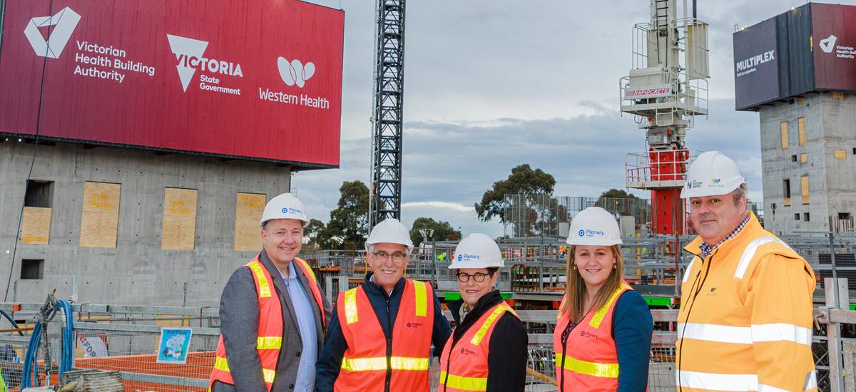 Image of staff in high-vis vests and hard hats on the new Footscray Hospital construction site. Pictured left to right: Western Health Executive Director of Nursing and Midwifery Shane Crowe, Plenary Health New Footscray Hospital Project Chair Kelvyn Lavelle, Western Health Chair Robyn Batten, Western Health Foundation Director Julia Harper and Western Health Chief Executive Adj. Prof Russell Harrison (credit: Shannyn Higgins)