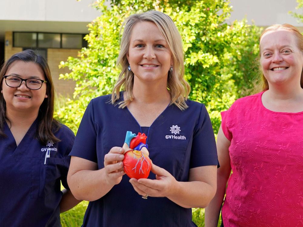 The cardiology team at Goulburn Valley Health standing and smiling while holding a heart model.