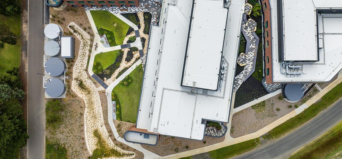 Bird's eye view of the green spaces at Latrobe Regional Hospitals, with pathways, grass, shrubs and water tanks visible