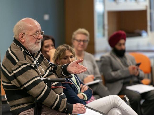 An audience member sharing an opinion