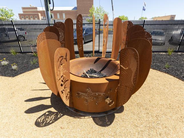 Outside landscaping and fire pit with Aboriginal colours and design, and native plants, at Ballarat and Aboriginal District Co-operative