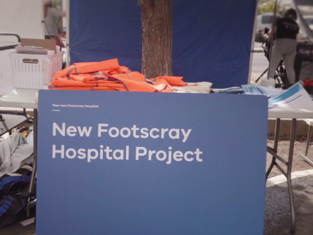 A pop-up stall with a blue sign that says 'New Footscray Hospital Project'