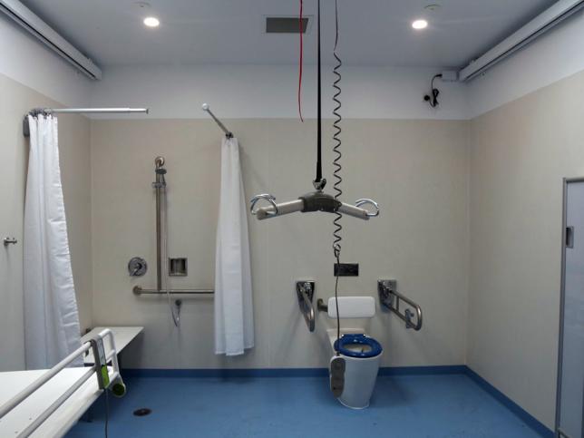 The interior of the changing places facility at Lake Pertobe showing a toilet, shower and lowered hoist