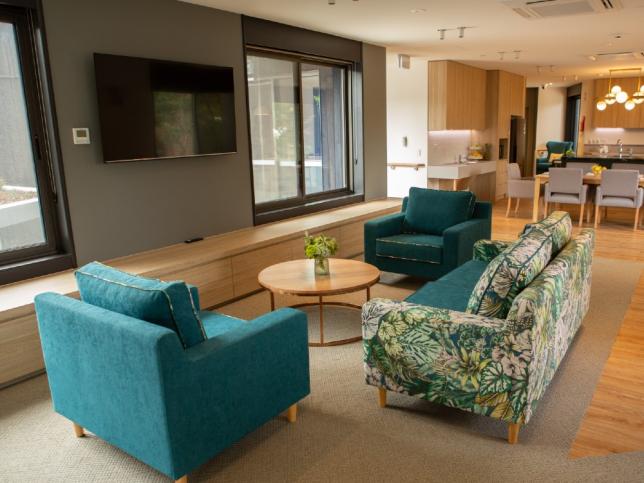 TV room of Creswick Nursing Home Dementia Friendly Unit showing longe seats facing wall mounted television