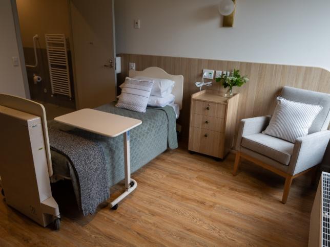 Bedroom of Creswick Nursing Home Dementia Friendly Unit showing single bed, draw unit and lounge chair