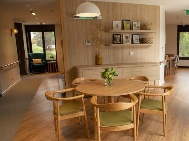 Communal living room of Creswick Nursing Home Dementia Friendly Unit showing table with five chairs