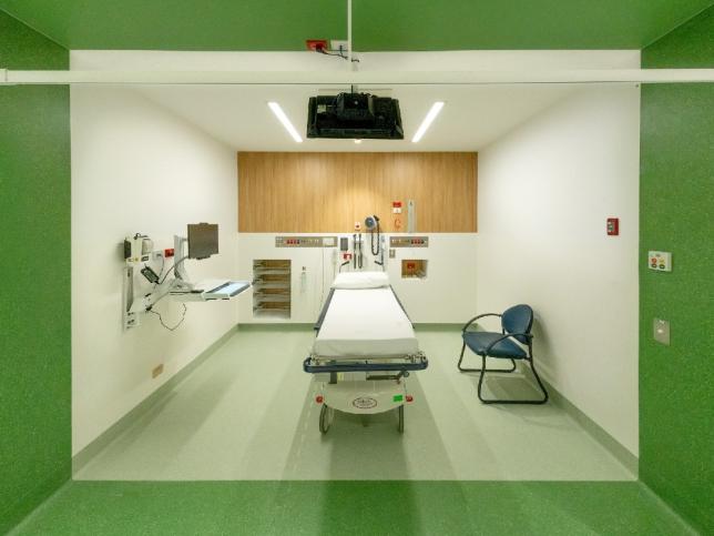 View of Emergency Department Cubicle with one gurney/bed and computer terminal on wall