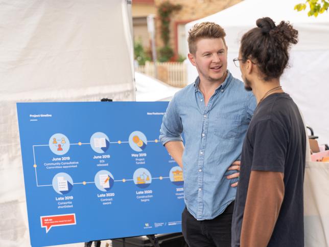 A VBHA staff member talking with a member of the community