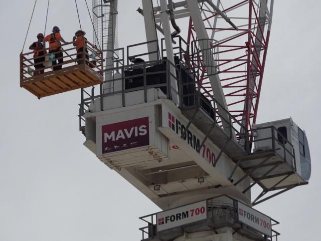 The bottom section of a crane, with a red sign that says 'Mavis'