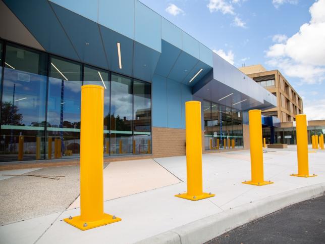 Modern hospital entrance with bollards in front