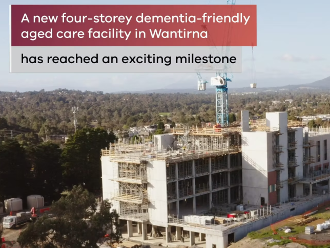 An aerial view of the Wantirna residential aged care facility with the words 'A new four-storey dementia-friendly aged care facility in Wantirna has reached an exciting milestone'