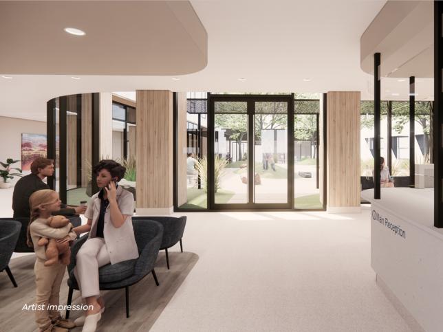 Artist impression of the main reception of the Phillip Island Community Hospital. A receptionist reads some paperwork while a mother and child wait on seats nearby. The waiting area is light and bright with views outside to the courtyard.