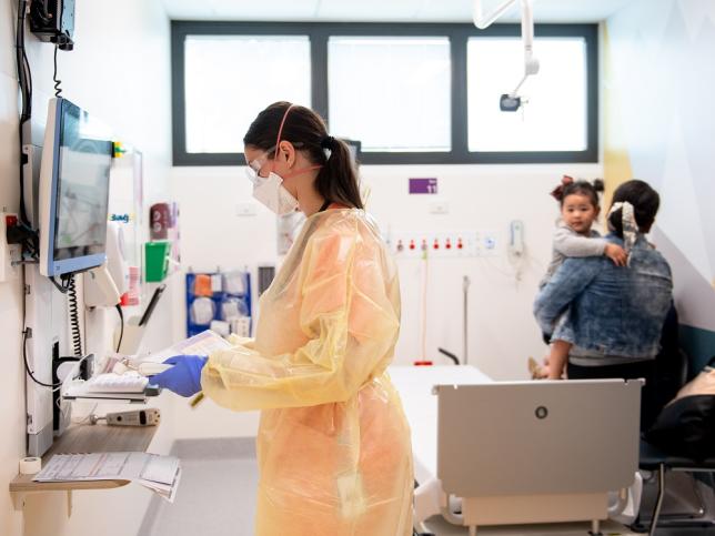 A photo of a nurse settling a child and their mother in a room of the children's emergency department at Sunshine Hospital.