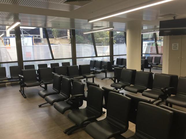 Waiting area at the Moorabbin Hospital. There are lots of chairs and a window that is all glass.