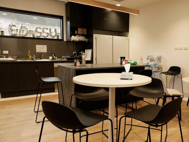 Communal chairs and tables and kitchen area in the short-stay area of the Shepparton Hospital emergency department