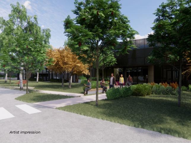 People walking and sitting near the entrance of the McKellar Centre. 