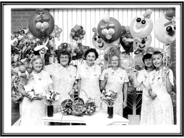 Black and white photo os members of the Frankston Hospital Pink Ladies holding ballons