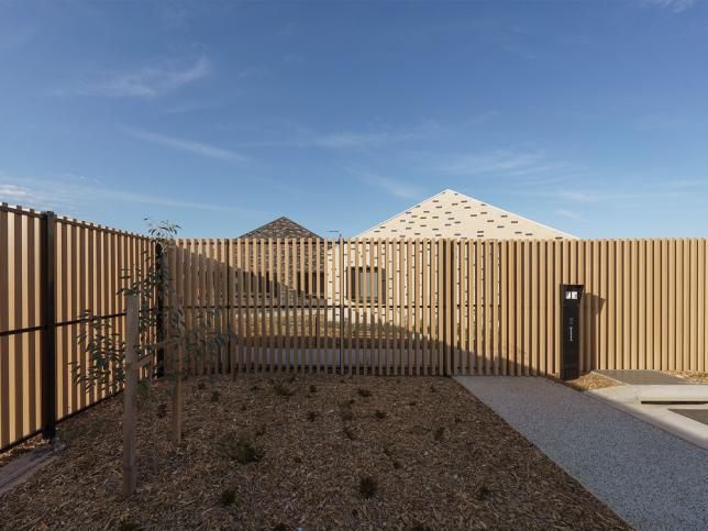 A landscaped courtyard lined with wooden fences