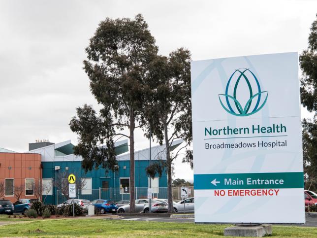 The signage for the main entrance of Broadmeadows Hospital in the foreground, with the hospital in the background