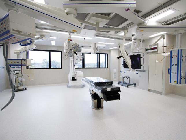 A view of a new operating theatre, with a table in the centre and adjustable lights fixed to the roof