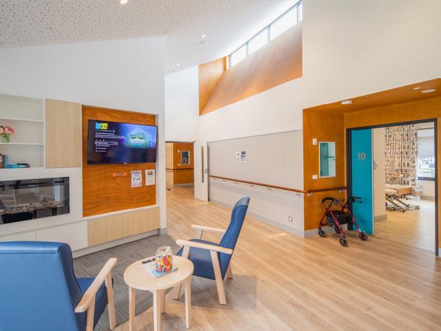 Communal living area with chairs and a television at Irvin House aged care facility