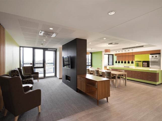 St George's aged care lounge area with TV and communal kitchen and dining area