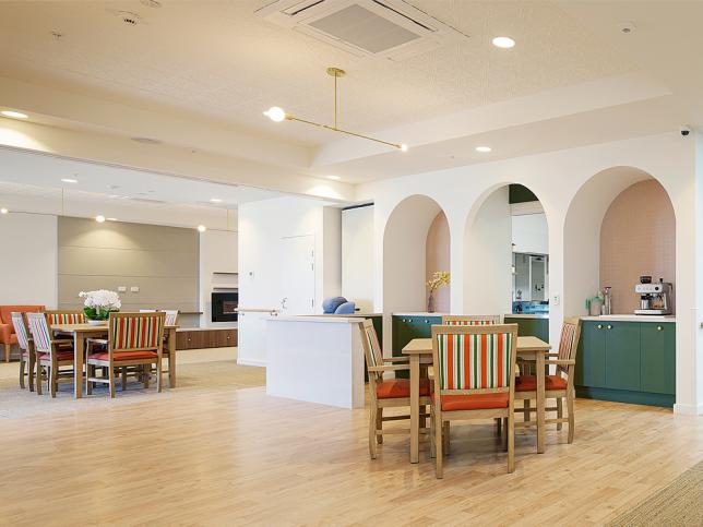 Upgraded interior dining area at East Wimmera Health Service Birchip Campus, with tables and chairs on a mix of wooden flooring and carpet