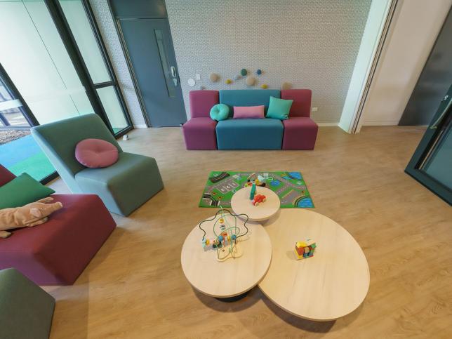 A sitting area with colourful couches and cushions