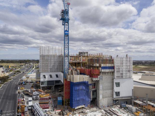 Wide shot aerial view of construction and a crane at the Northern Hospital.