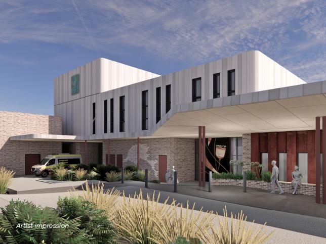 Artist impression of the Southern facade of the Phillip Island Community Hospital. The hospital will be two stories high and the outside is a sandy coastal color with hints of maroon. There is a large verandah for weather protection and native plants surround the facility.