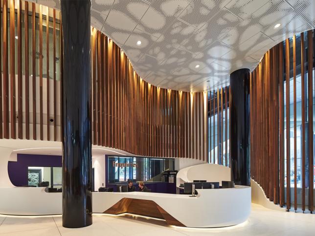 Two people sitting at the front reception desk in the lobby of the Victorian Comprehensive Cancer Centre