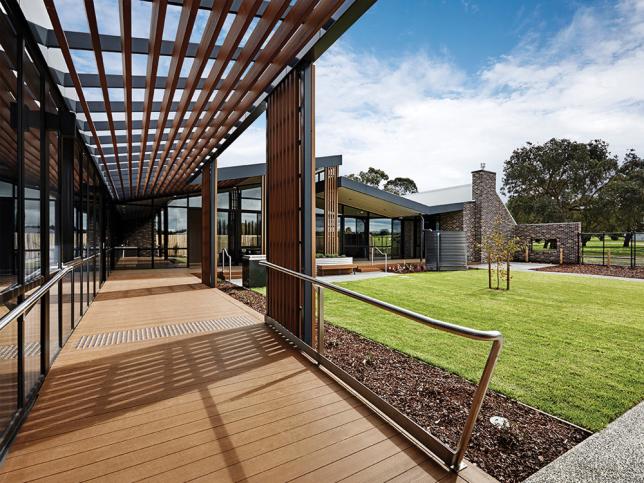 Outdoor timber decking next to a grassed courtyard area