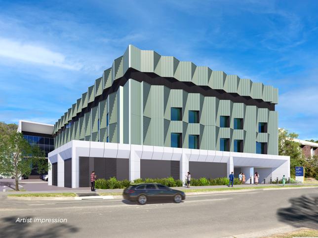 An artist impression of an exterior view of the Angliss Hospital expansion from Edward Street. The building has a green facade with a white exterior on the ground floor.