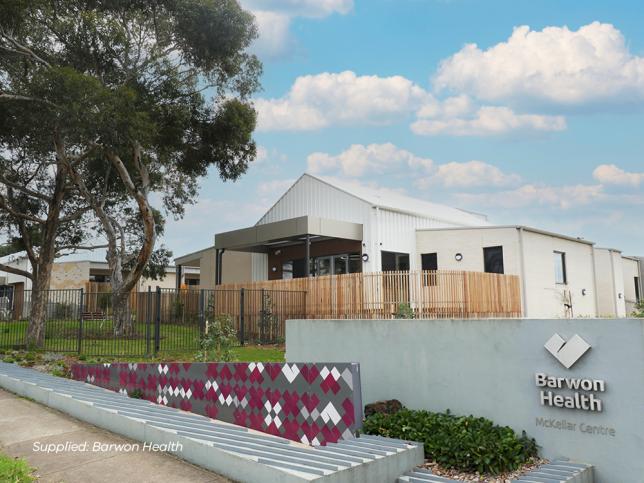 Exterior view of the facade of the Geelong EPC, with white walls and a timber fence. The Barwon Health logo is visible in the bottom right