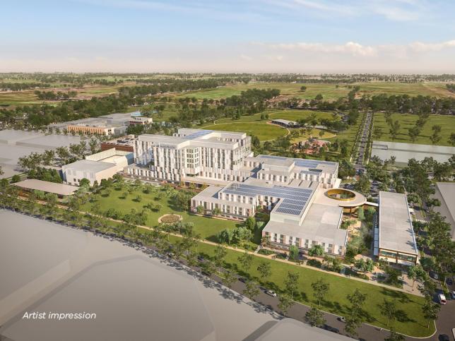 Artist impression of an aerial view of the exterior of New Melton Hospital, seen during the daytime, with multiple buildings with white facade located among green space