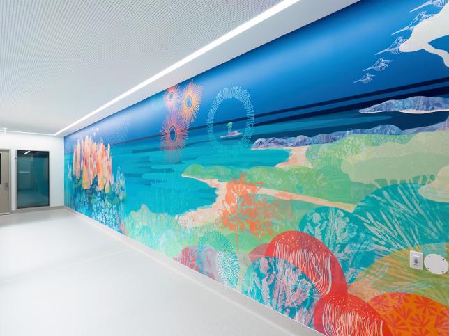 A mural of land, waterways and marine animals in a corridor, with white ceiling and floor