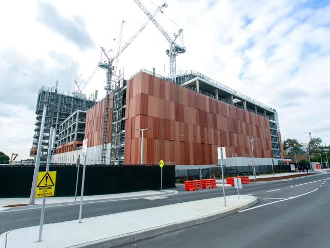 A view from the street of red and brown facade panels on the exterior of the Frankston Hospital redevelopment