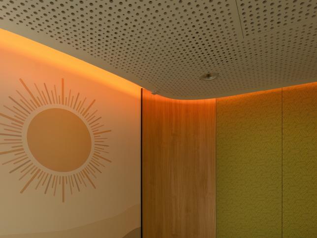 A soft glow emits from the corner of the room that also sports a sun motif