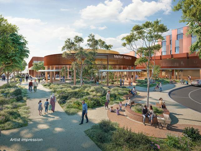 Artist impression of the street view of new Melton Hospital's main entrance and drop-off area, with people walking around paths with greenery in the foreground and the hospital in the background.