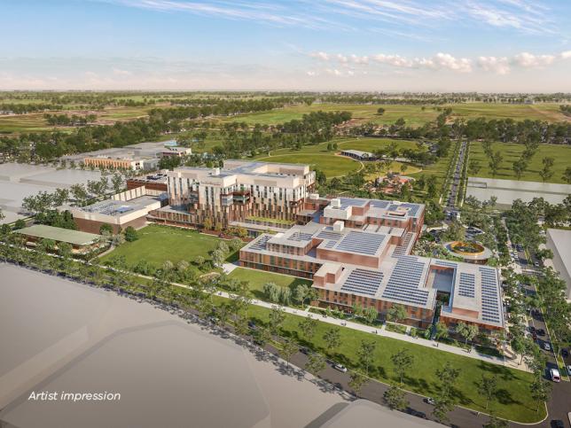 Artist impression: exterior view from the north of new Melton Hospital with a building surrounded by greenery