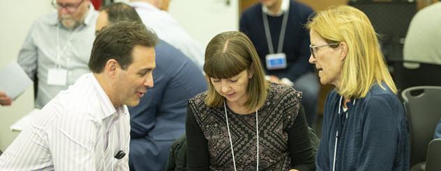 Two women and a man in discussion