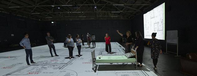 People walk around on life-sized plans of the new Wantirna aged care facility