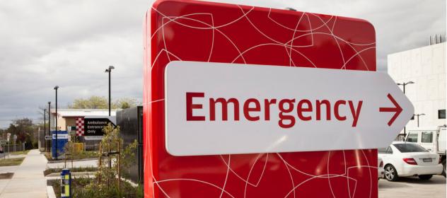 Large red sign with the word Emergency and an arrow pointing right